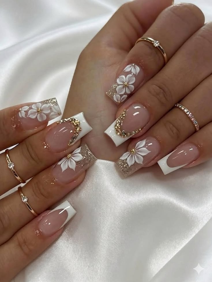Long nude almond nails with glossy gold chrome accents and sculpted details