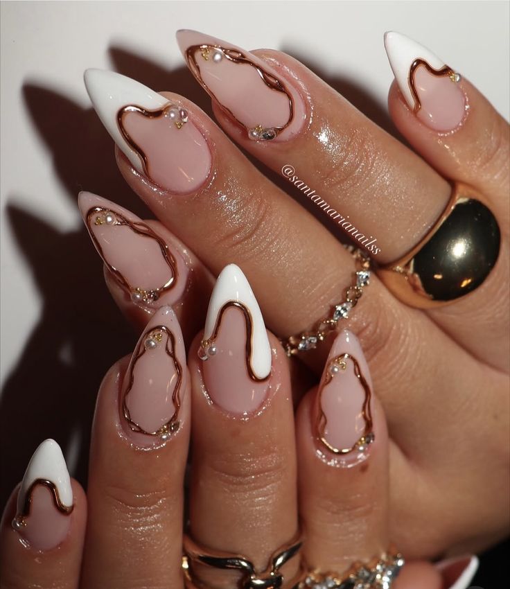 Glossy pink almond nails with dimensional white flowers and crystal centers